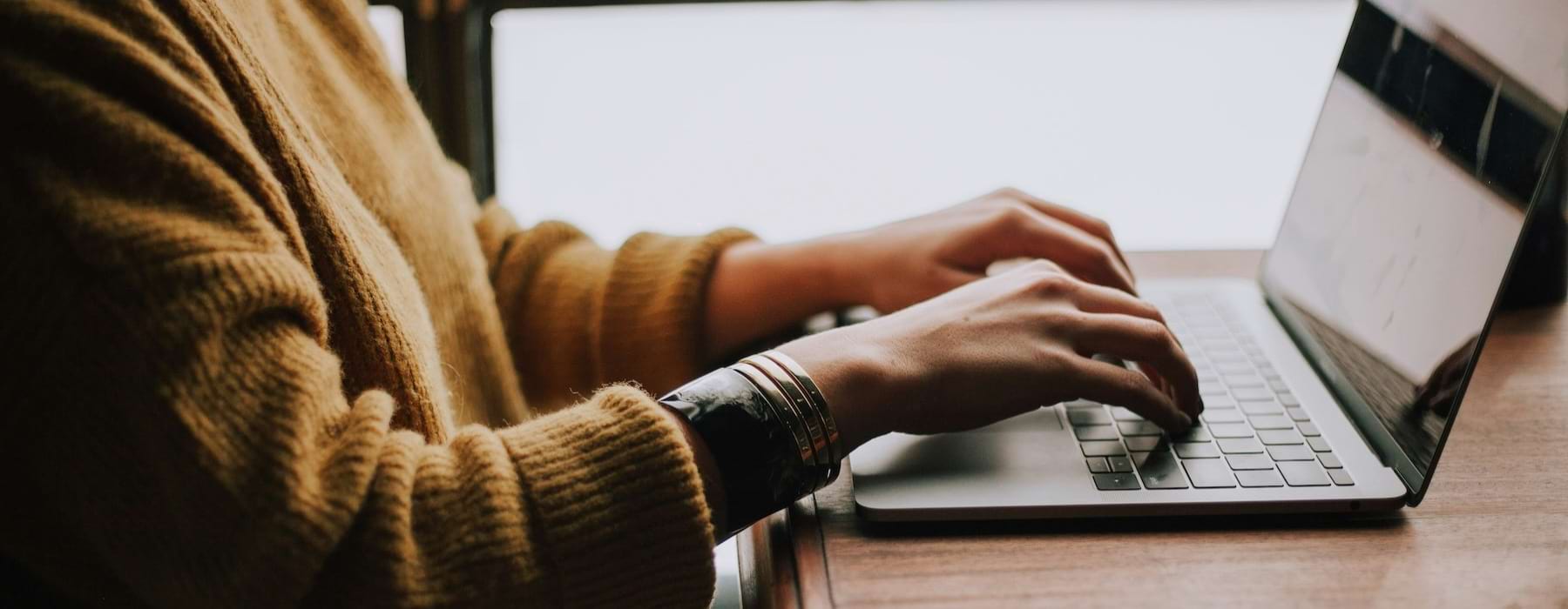 a person typing on a laptop