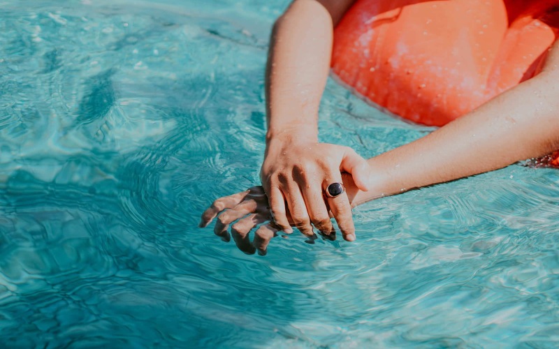 woman relaxes on a floaty in swimming pool